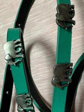 Teal leather belt with silver elephant details and elephant earrings.